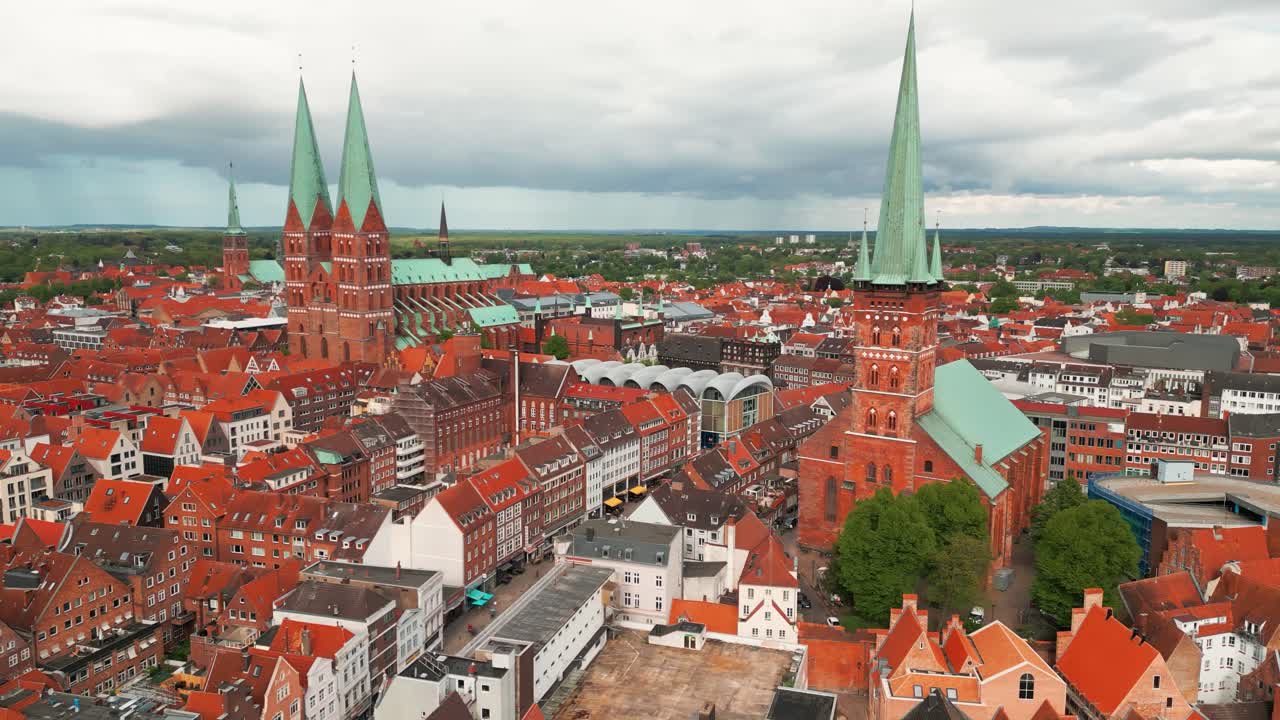 aerial shot over Lubeck city center showing Saint Marie Church and Saint Peter Church on an overcast day, Schleswig-Holstein land, Germany
