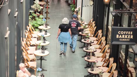 two people walking in a cardiff shopping arcade