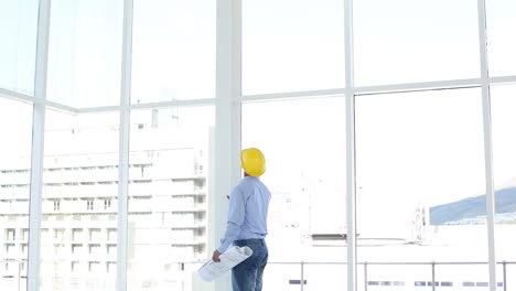 handsome architect studying blueprints