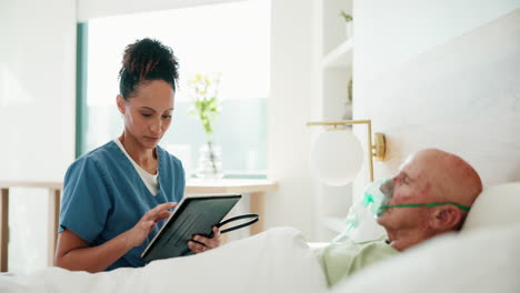 nurse assisting elderly patient in hospital bed
