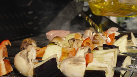 Chef-Drizzling-Olive-Oil-on-Vegetable-Shish-Kebabs-with-Mushrooms,-Aubergine,-Peppers-in-Slow-Motion