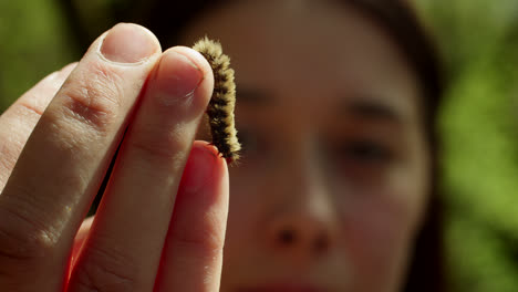 woman holding a caterpillar