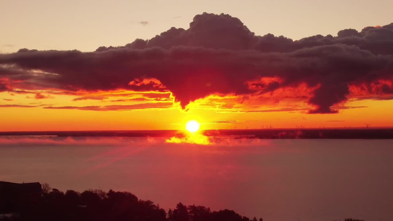 Still shot of an intense yellow sun landscape full of clouds