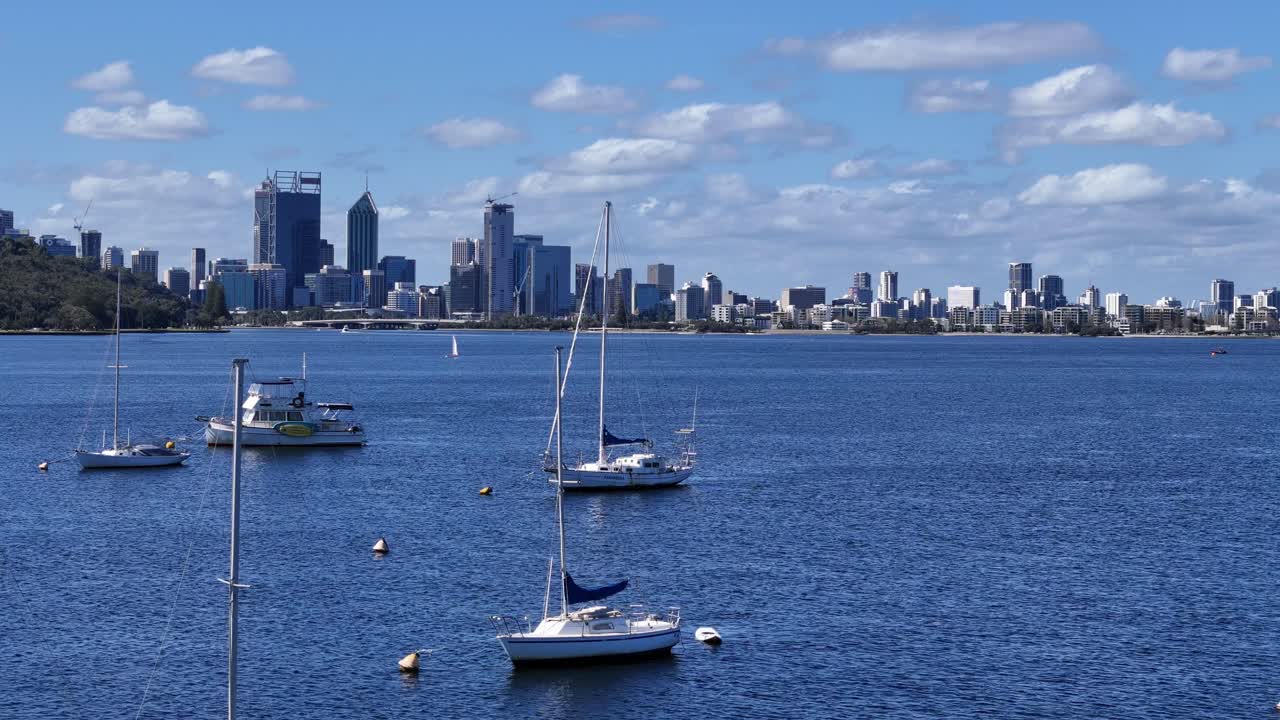 Flying through group of anchored sailing yachts towards Perth city