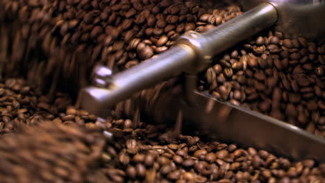 closeup of coffee beans mixing in cooling drum after being freshly roasted