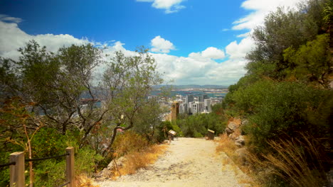 panoramic view of gibraltar city from hillside, urban landscape, coastal cityscape, sunny day, mediterranean sea, residential areas, clear sky, vibrant colors, urban development, scenic overlook