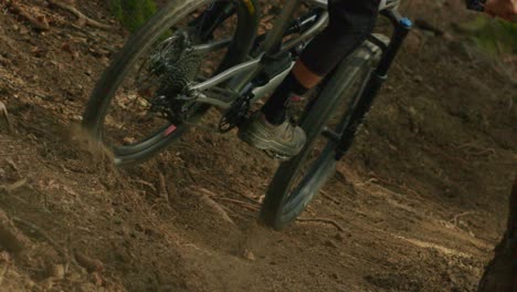 mountain biker kicks up dust in slow motion