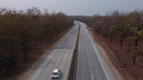 Drone-shot-of-the-iconic-NH44-Srinagar-to-Kanyakumari-6-lane-Highway-that-cuts-through-the-Pench-National-Park-with-underpass-for-wild-animals-to-cross,-India