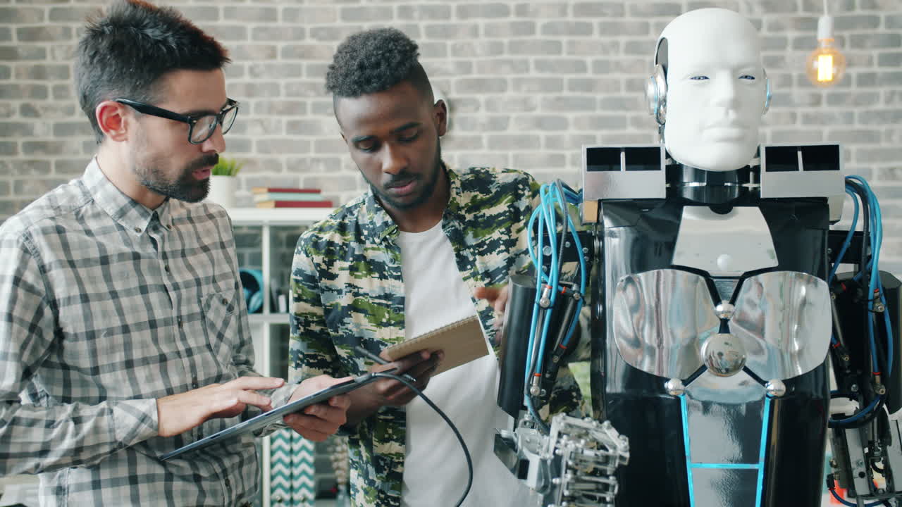 Two engineers working on a robot