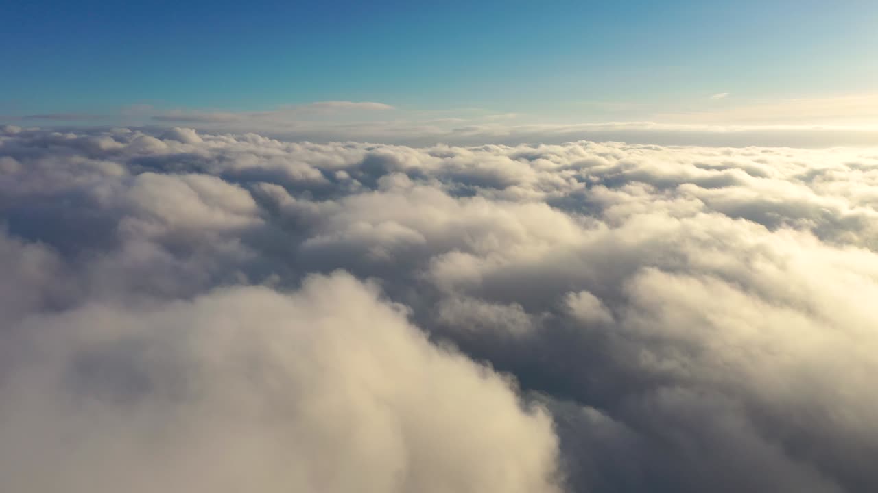 Time lapse beautiful sky with clouds at the sunrise. Timelapse of sunset clouds with blue sky. Flight through the moving cloudscape. Texture of clouds. Panoramic view. Clouds in motion. Airplane view