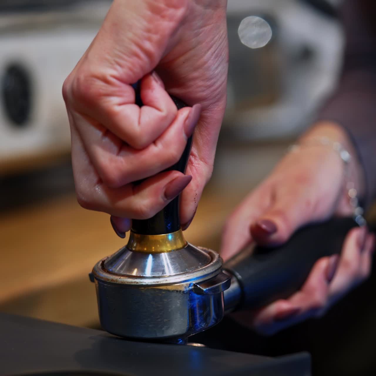 Woman prepares coffee.Barista filling the grinding coffee beans into the special part of coffee machine. Making coffee at home. Close-up.