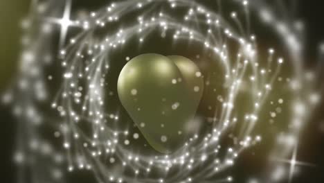 Animation-of-light-spots-and-circles-over-gold-heart-on-black-background