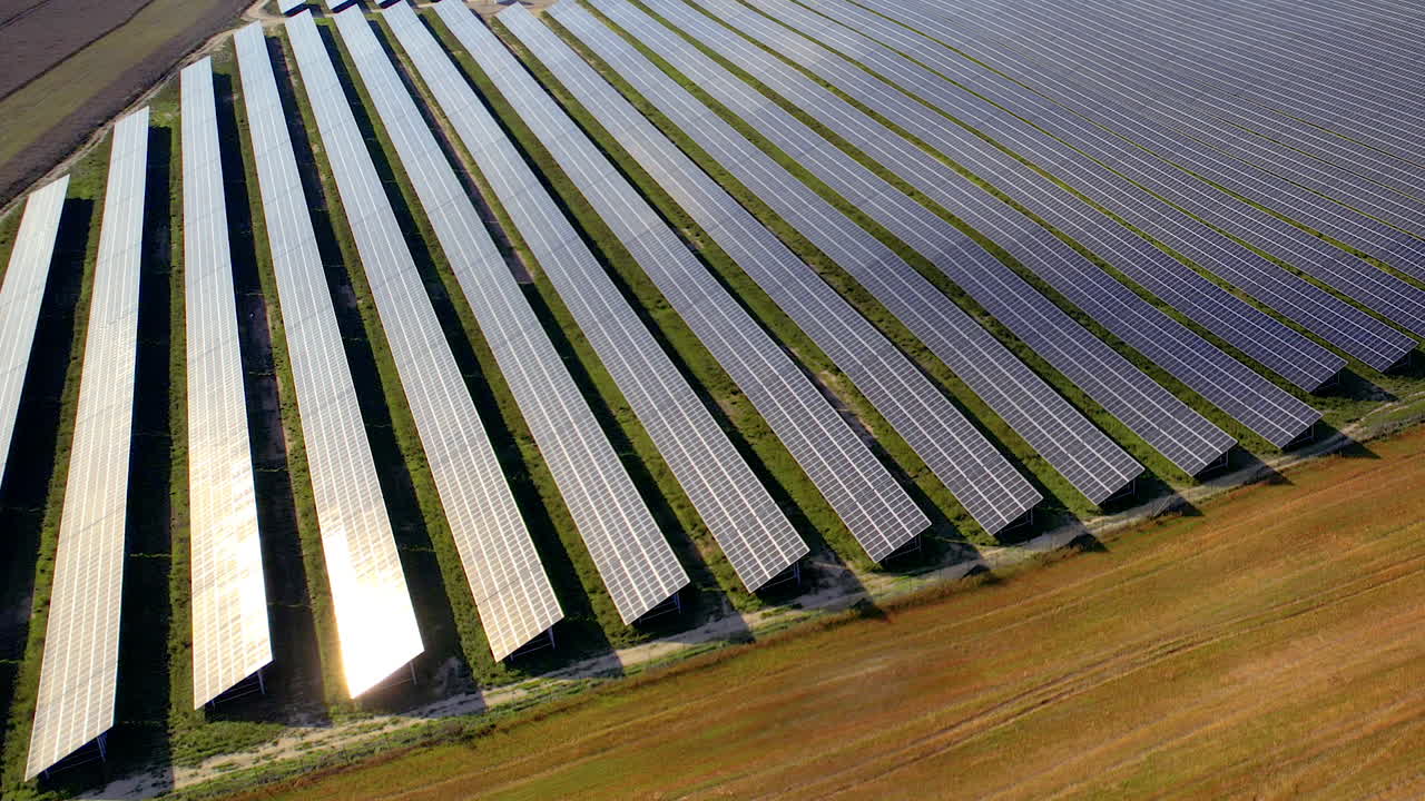 Drone shot over solar panels farm - top down move