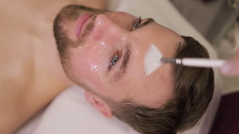 man receiving facial treatment