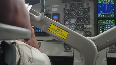 Steering-wheel-of-seaplane-with-yellow-caution-label,-control-dashboard