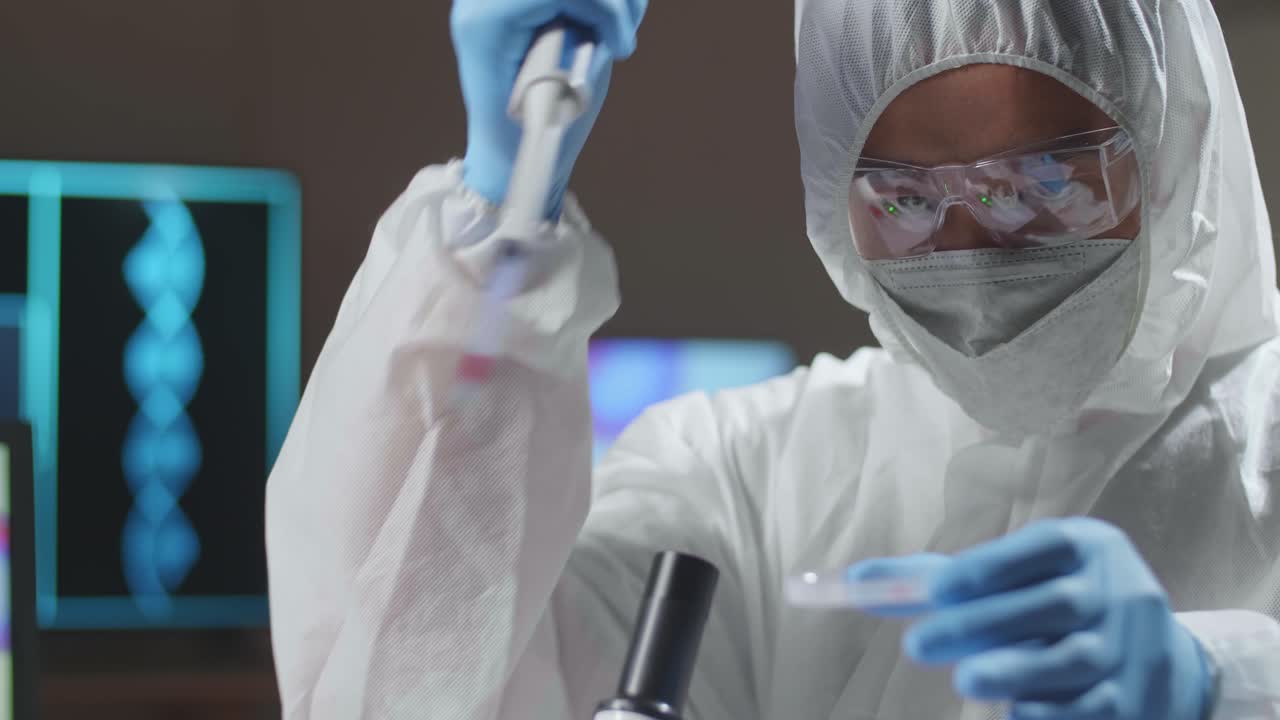 Asian Doctor In Protective Suit Is Doing A Science Experiments And Developing Vaccine In A Modern Lab. Laboratory Assistant Workplace. The Concept Of Science And Medicine
