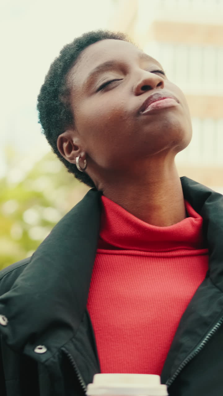 Young African Woman Enjoying a Peaceful Moment with Coffee Outdoors