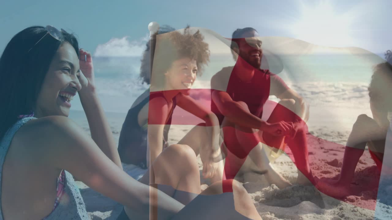 Four friends sitting on sand, red cross flag waving, obscuring and revealing faces for health