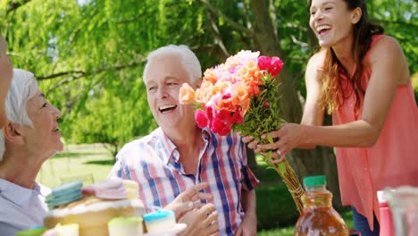 family celebrating birthday party in the park