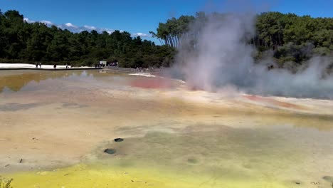 Hot-smoke-being-emitted-from-a-thermal-lake-known-as-Champagne-Pool-at-Wai-O-Tapu-near-Rotorua,-New-Zealand-a-popular-tourist-attraction