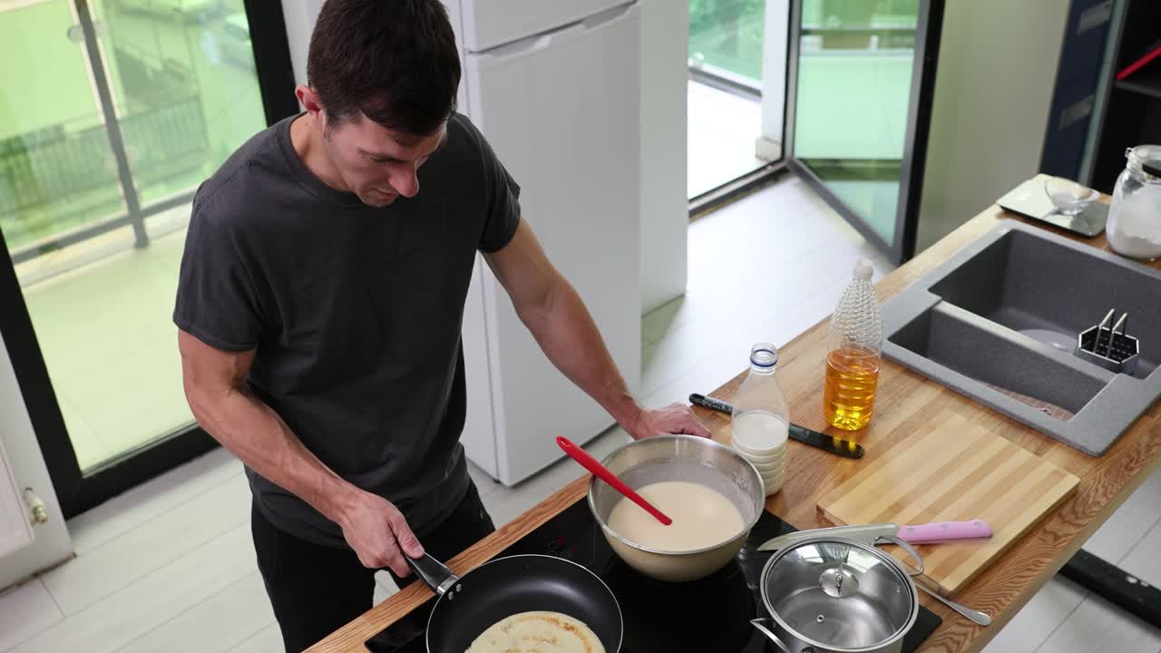 Man making pancakes in the kitchen