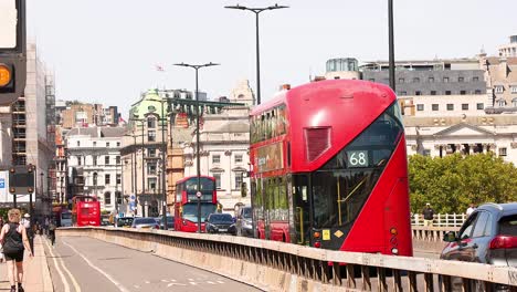 red double-decker bus crossing a bridge