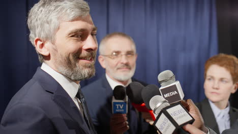 politician giving interview to group of journalists