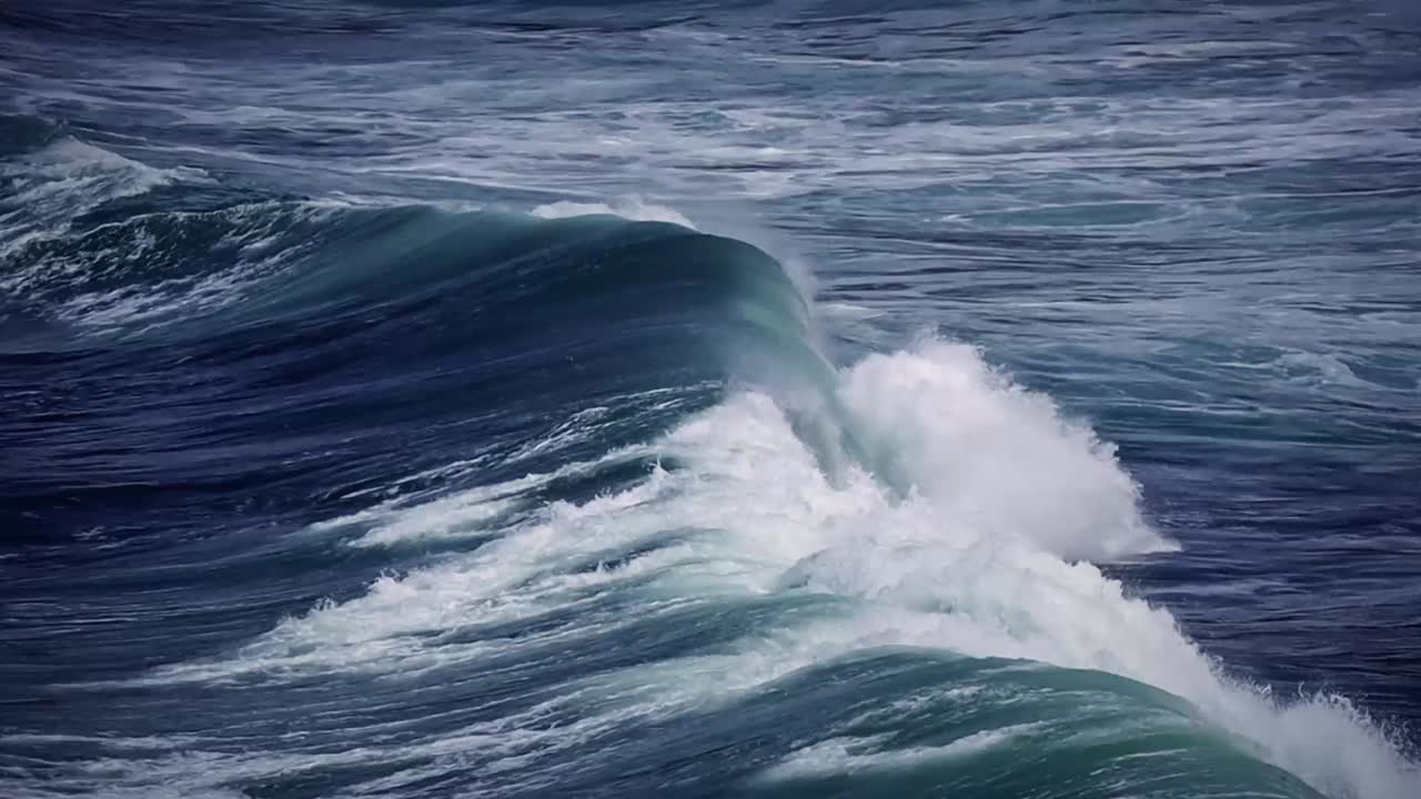 Immerse yourself in the raw energy of nature with this dramatic footage of ocean waves in motion. Towering swells surge forward