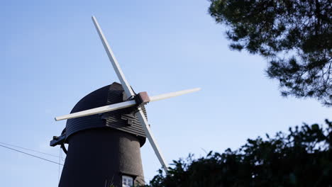 Wide-shot-of-old-Victorian-Bursledon-Windmill-against-sunny-blue-sky-4K