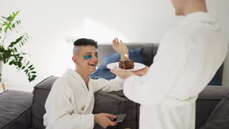 Male-gay-couple:-a-man-surprising-boyfriend-with-cake-and-candle