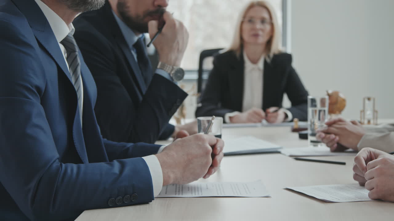 Businessmen with Lawyers Having Meeting in Office