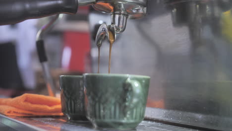 Coffee-maker-pours-coffee-into-vintage-cup