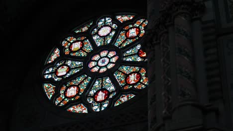 revealing shot of intricate decorative stained glass panes in a church