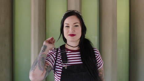 portrait of beautiful young woman with tattoos smiling confident wearing stripe shirt