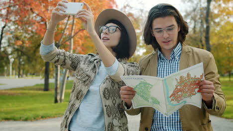 couple exploring a city park with a map