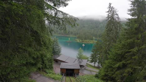 Gopro-view-of-a-cable-car-ascent-in-a-forest-next-to-leave-a-cristal-clear-alpine-lake-in-the-Swiss-Alps