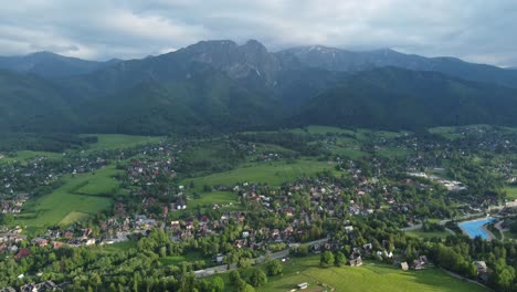 valley view from gubałówka - landscape flyover of snowcapped polish tatry mountains, farmland, forests, and legendary giewont peak near zakopane, poland - 4k 30fps smooth tracking forward-5