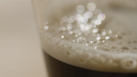 close up of pint of irish stout in glass to celebrate st patricks day