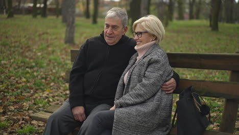 elderly couple enjoying a moment of affection on a park bench