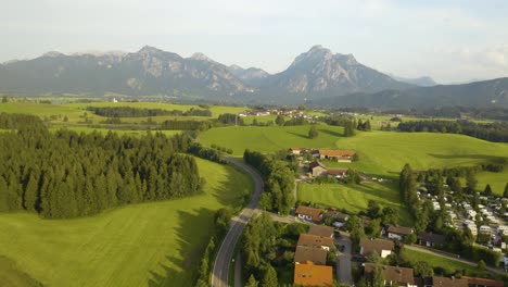 Aerial-Establishing-Shot-of-Rural-Village-in-Europe,-Mountain-in-Background