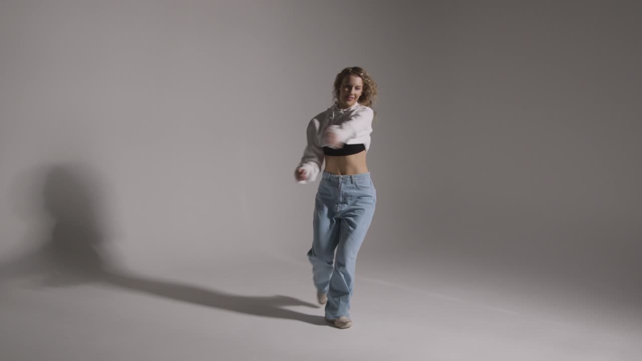 Full Length Studio Shot Of Young Woman Having Fun Dancing Against Grey Background 7