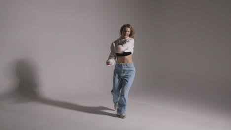 Full-Length-Studio-Shot-Of-Young-Woman-Having-Fun-Dancing-Against-Grey-Background-7