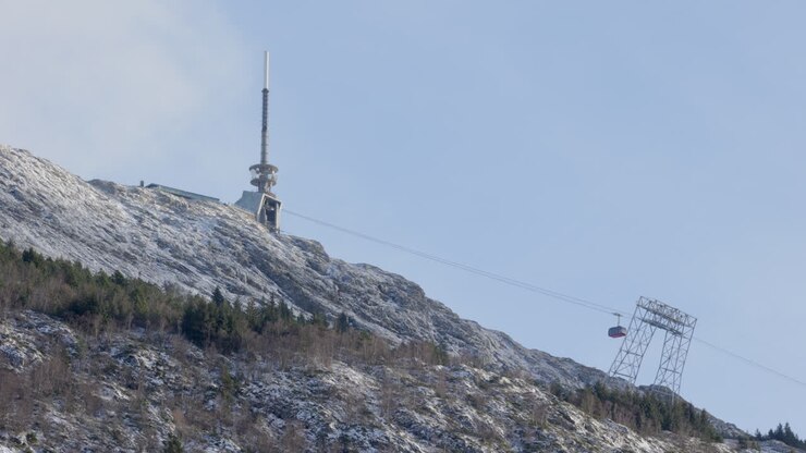 One of the Ulriksbanen cable cars ascending towards the summit of mount Ulriken on a winter day