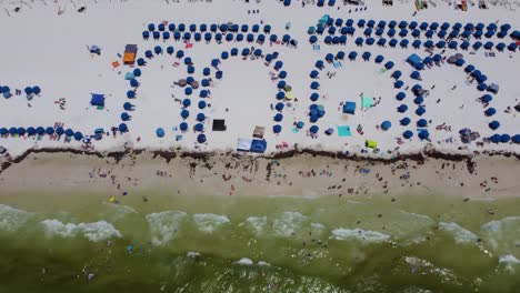 okaloosa island fort walton beach destin florida. tourist chairs lined up on white sandy beach, view of beach chairs umbrella on the beachfront resort. travel destination. tropical travel.
