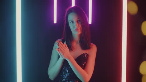 woman in sequined dress under neon lights