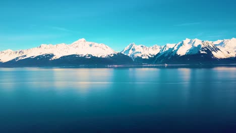 4k drone video of seward, alaska beach and surrounding snow covered mountains on snowy winter day