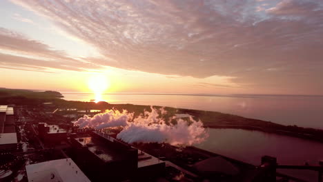 sunrise through clouds of industrial smoke on lake superior