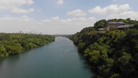 rising shot of town lake in austin tx, shot slowly pans to reveal the cities downtown skyline in the background