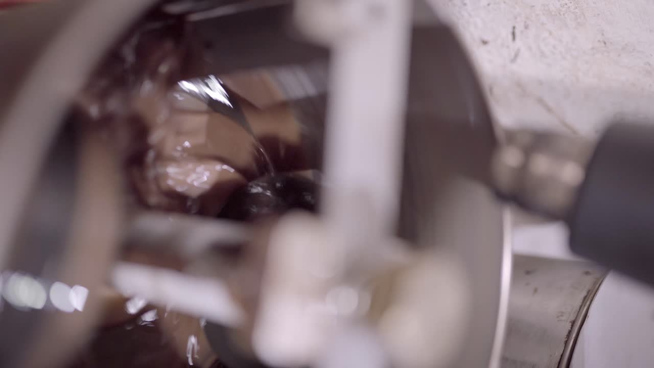 Delicious liquid chocolate mixing in conching machine