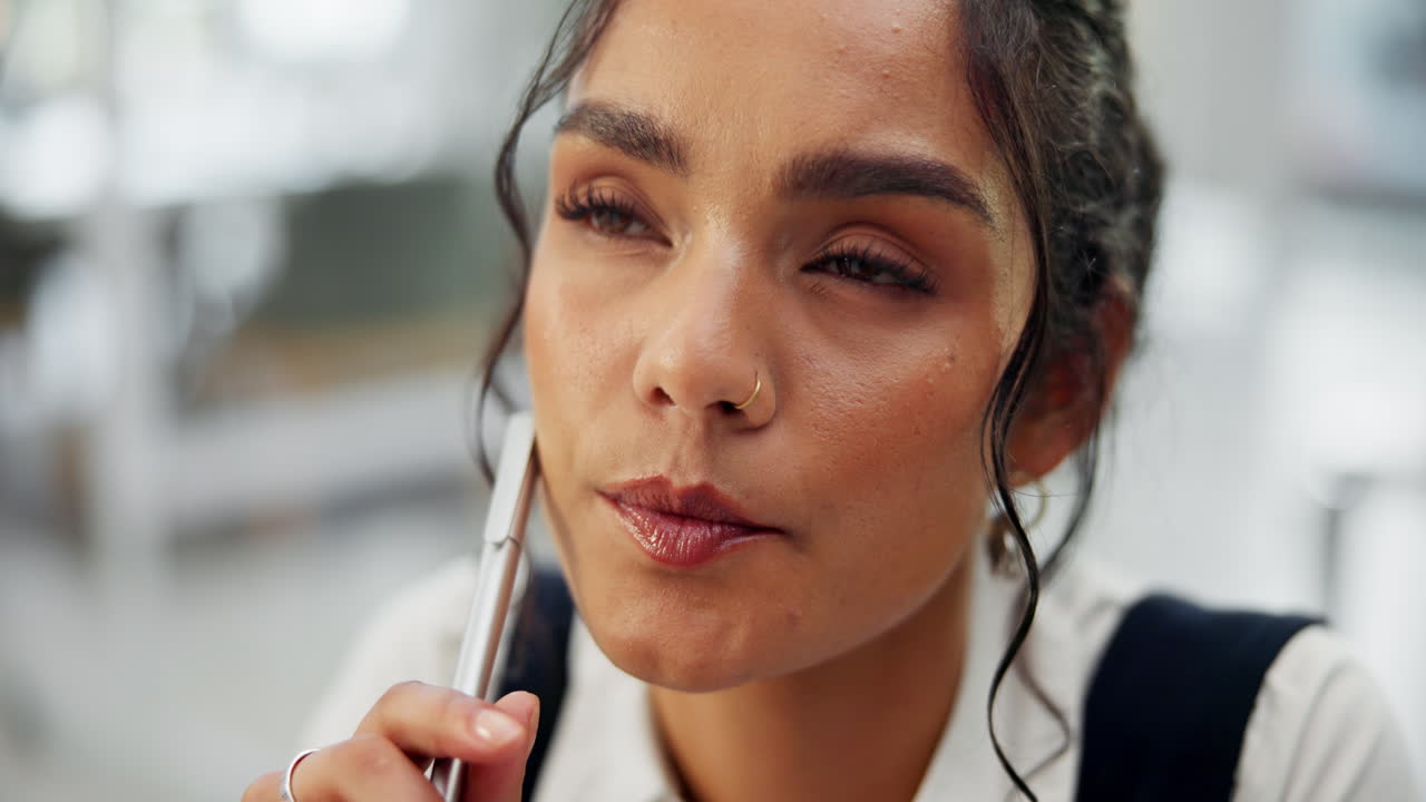 Woman thinking with pen